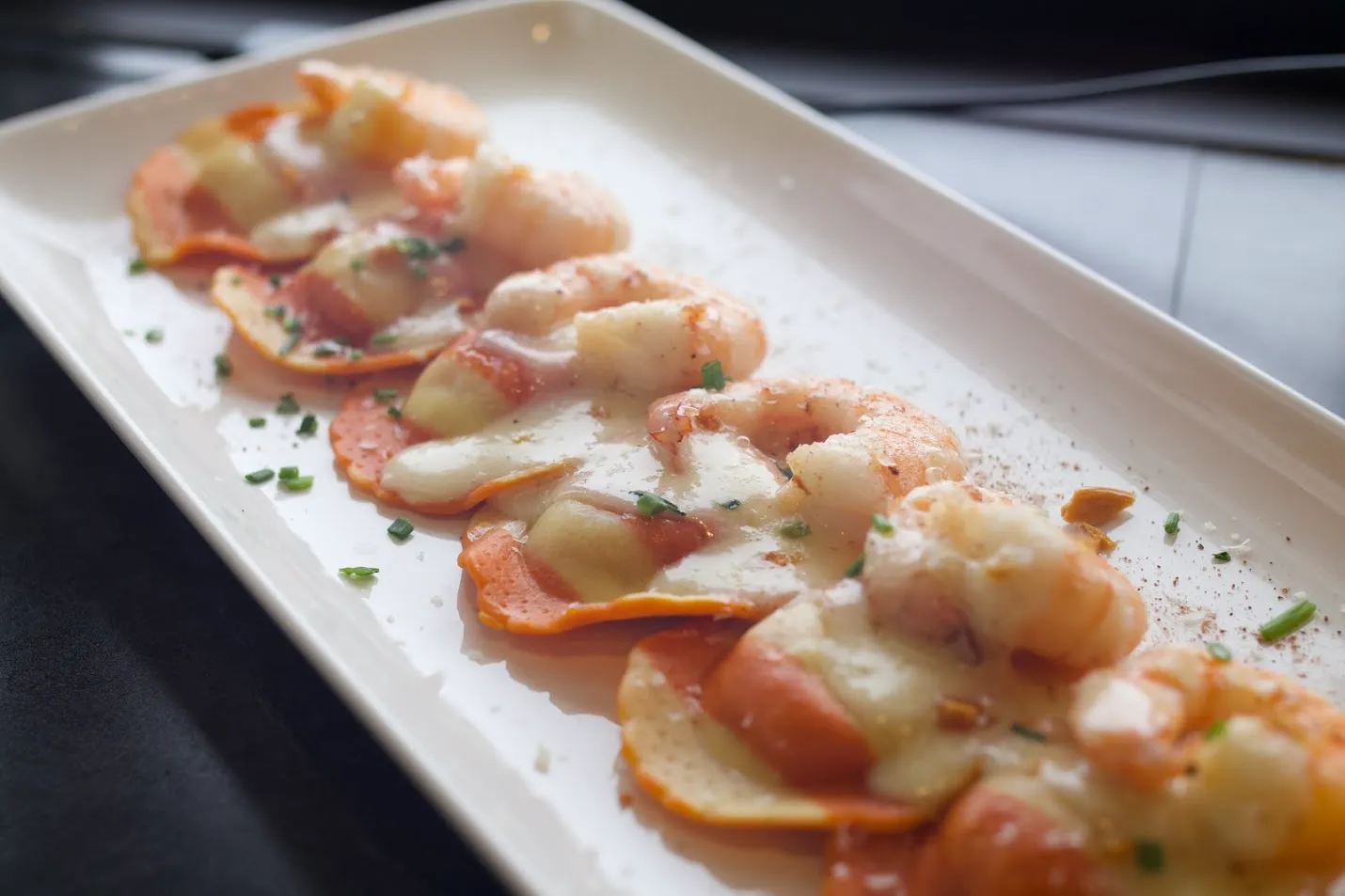 Shrimp ravioli with cream sauce and herbs